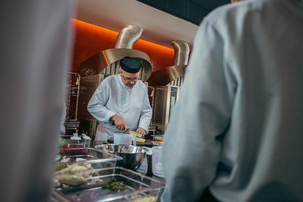 Experienced chef training local talents in Red Sea Global resorts, Thuwal luxury private retreat.